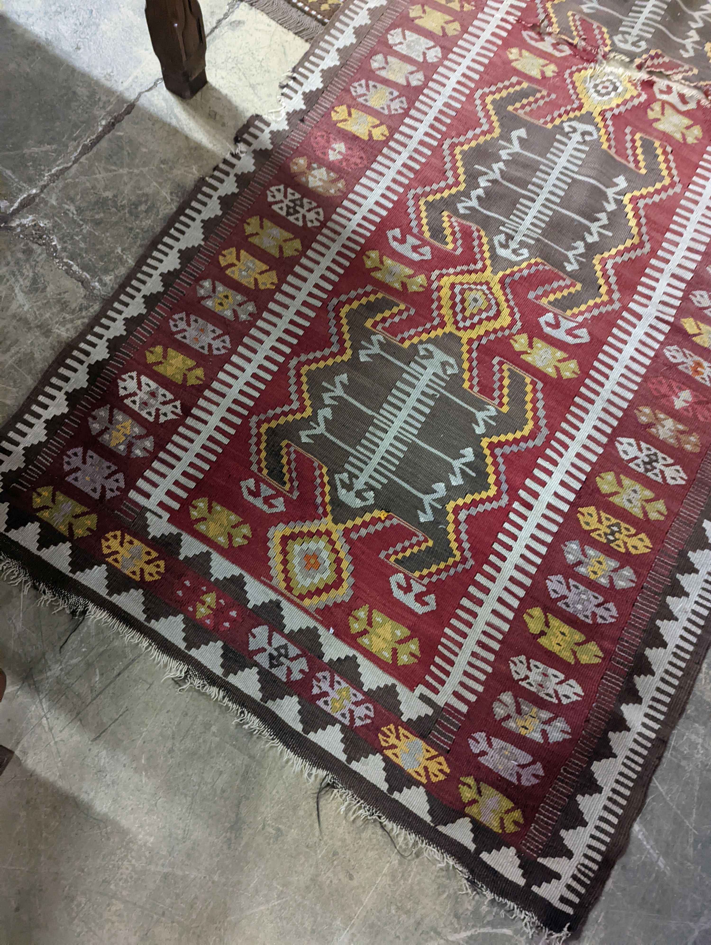 A Kilim polychrome flatweave runner, 380 x 118cm (holed)